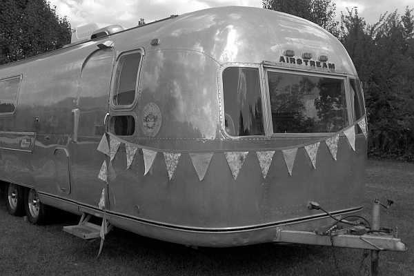 Airstream travel trailer in black and white with double axle (two wheels on each side)