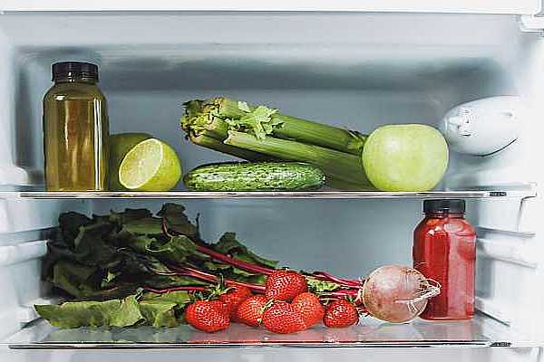 Inside of a refrigerator with fresh vegetables and fruit